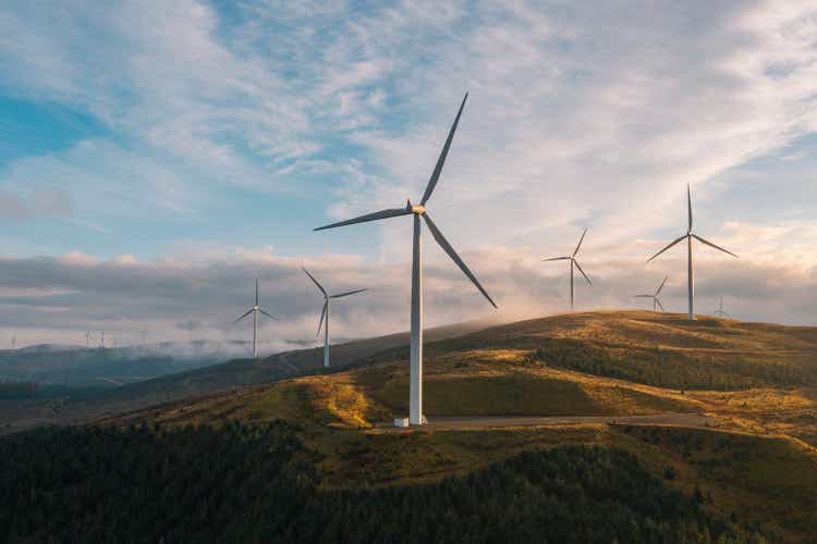 A sunset drone view of a wind farm on a hilltop in Scotland