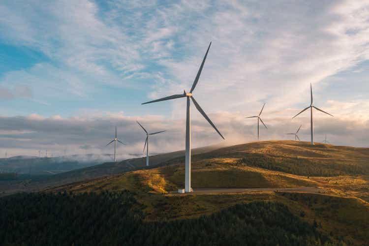 Drone view at sunset of a wind farm on a hilltop in Scotland