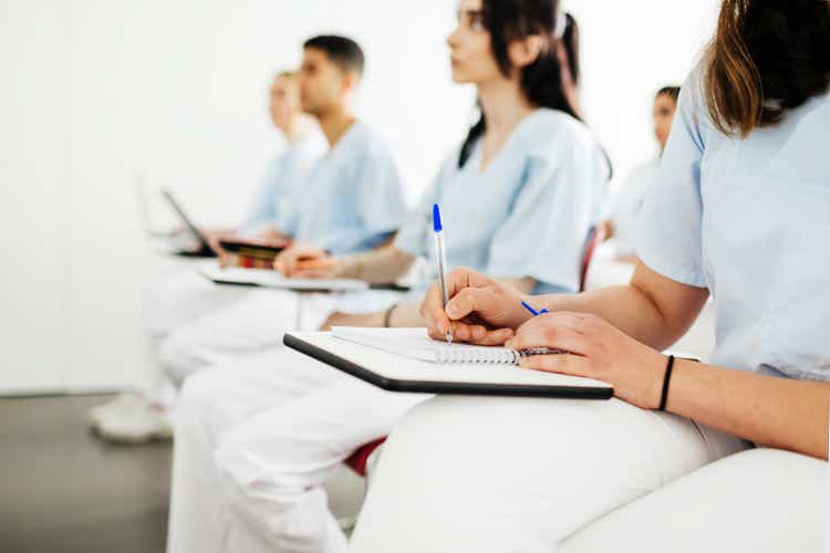 Student Dentists Taking Notes During Lecture