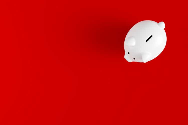 White ceramic piggy bank on red background. Saving money, investment, financial growth concept. Financial planning for the future. 3D rendering.