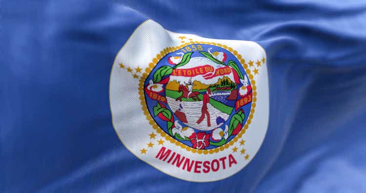 The US state flag of Minnesota waving in the wind