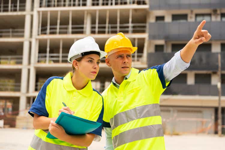 Civil engineers checking work process in construction site