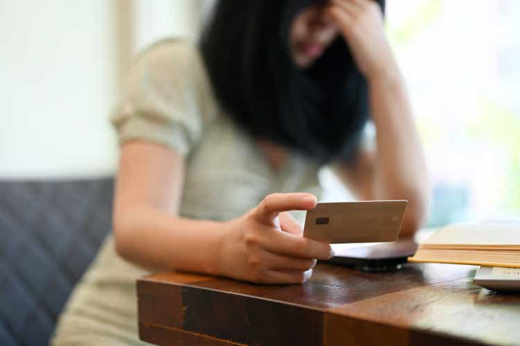 Stressed and broke young Asian woman having a problems with her credit card service