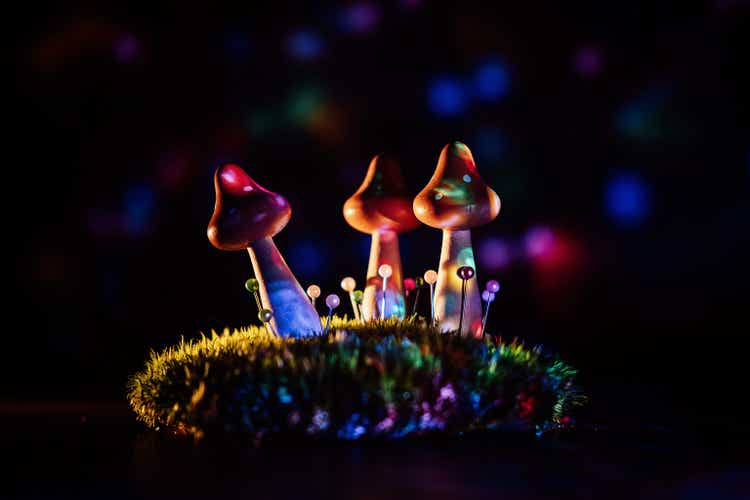 Psilocybin therapy as a treatment for mental health problems.  psilocybin psychotropic magic psilocybin mushrooms on dark neon background