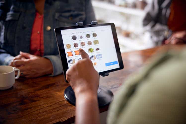Employee uses point of sale app on tablet