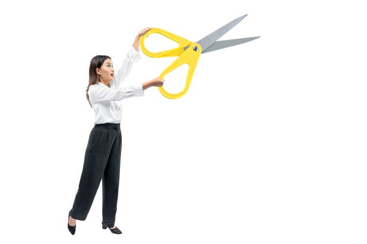 Asian businesswoman holding scissors