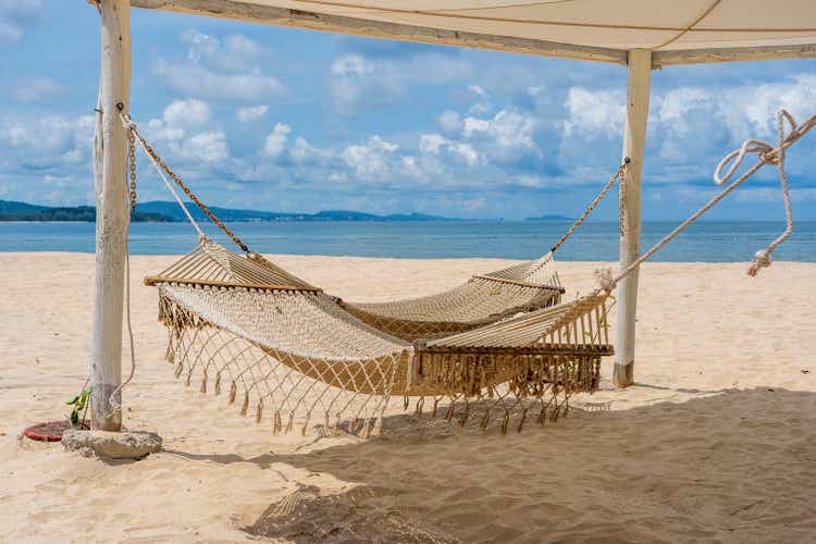 Recreation area with wicker hammocks on the sandy beach next to the sea on the tropical island Phu Quoc, Vietnam