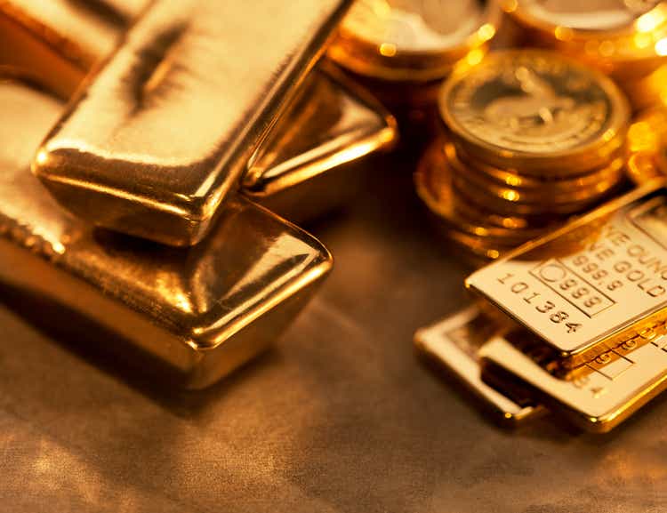 Close-up of gold bars and gold coins