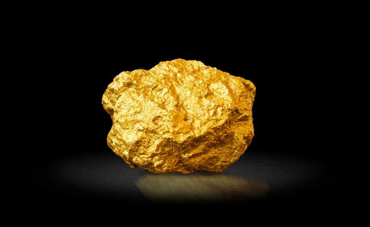 Gold nugget on a black background. Precious metal, wealth concept, investment, contribution.