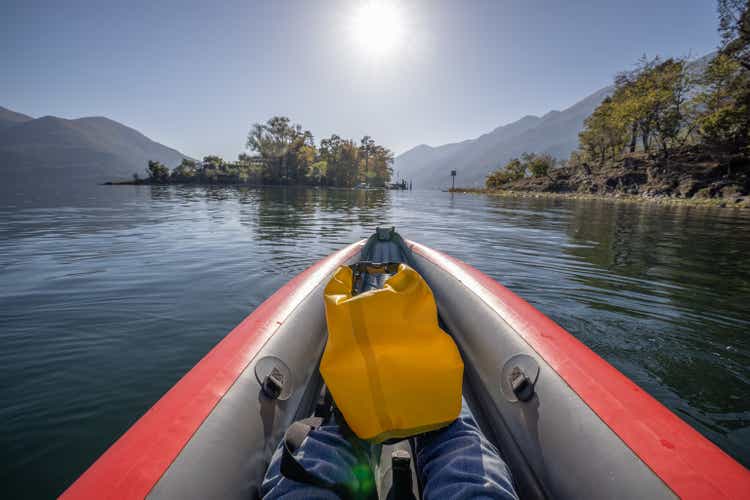 View of feet from inflatable canoe in Switzerland