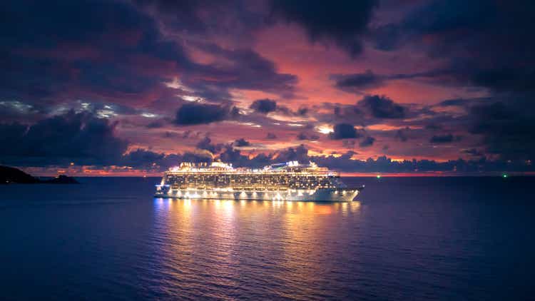 Cruise ship at sea aerial view with dramatic clouds at sunset in the Andaman Sea, Phuket, Thailand