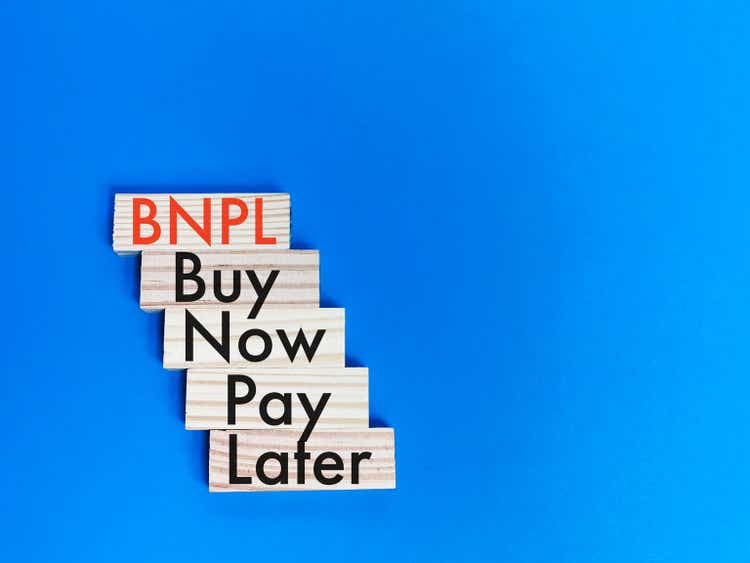 Concept of buy now pay later on wooden blocks.