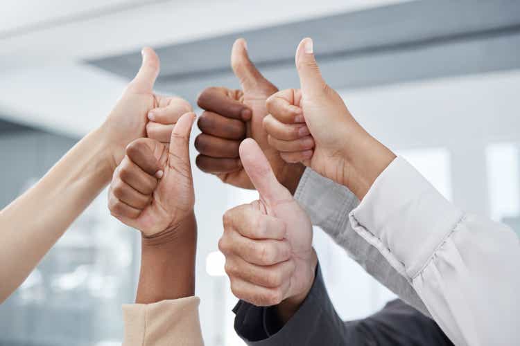 Thumbs up, team and success gesture to show work community, unity and gratitude.Office business collaboration, teamwork and diverse people agreeing gestures