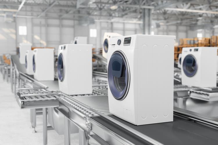 Close-up View Of Washing Machines On Conveyor Belt In Warehouse