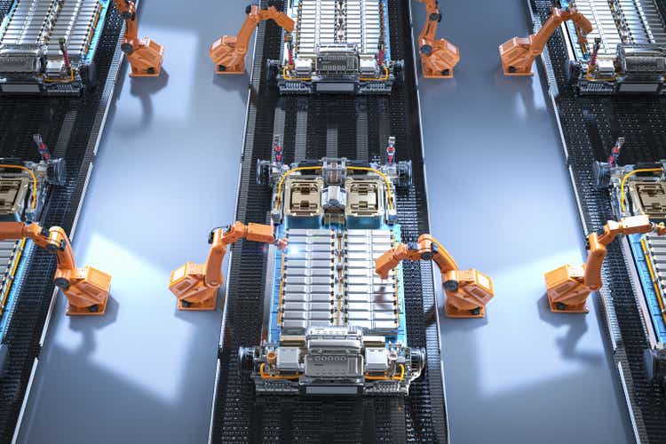 Robot assembly line with electric car battery cells module on platform