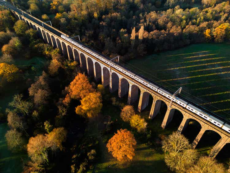 Aerial view of a train passing over a viaduct