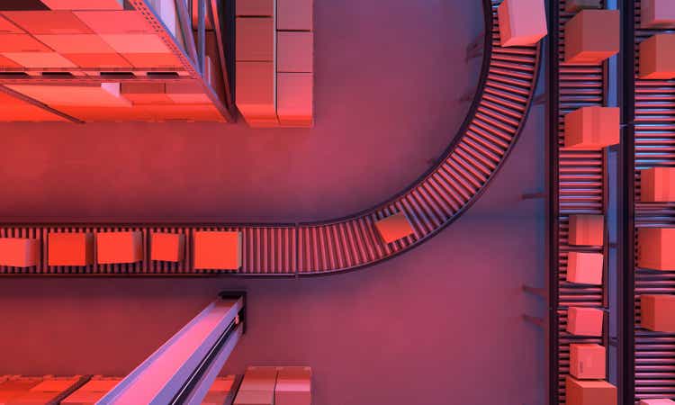 Top view of conveyor belts transporting boxes in a large warehouse, night time