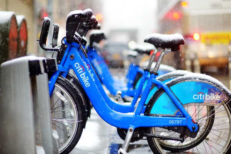 Row of Citi bike rental bicycles at docking station in New York City. Shared bikes lined up in the street of NYC, USA.