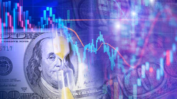 One hundred dollar bill with hourglass on the background of Candlestick charts as a concept of Stock trading