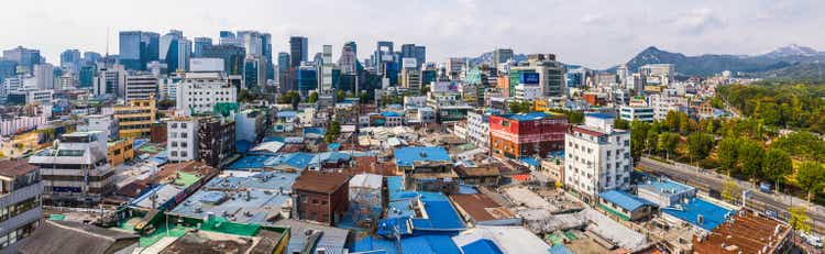 Aerial panorama over crowded cityscape rooftops downtown skyscrapers Seoul Korea