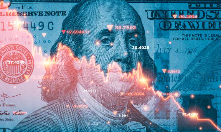 Benjamin Franklin facing dollar banknotes and red decreasing stock market chart as symbol of recession crisis concept.