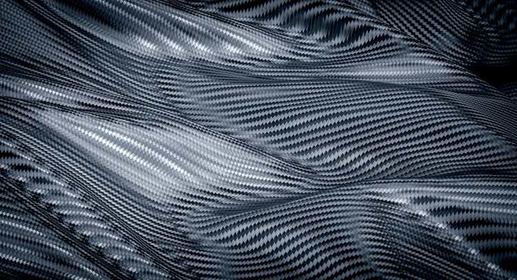 Wave background in carbon fiber texture.