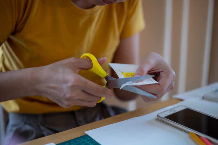 woman"s hand cutting paper