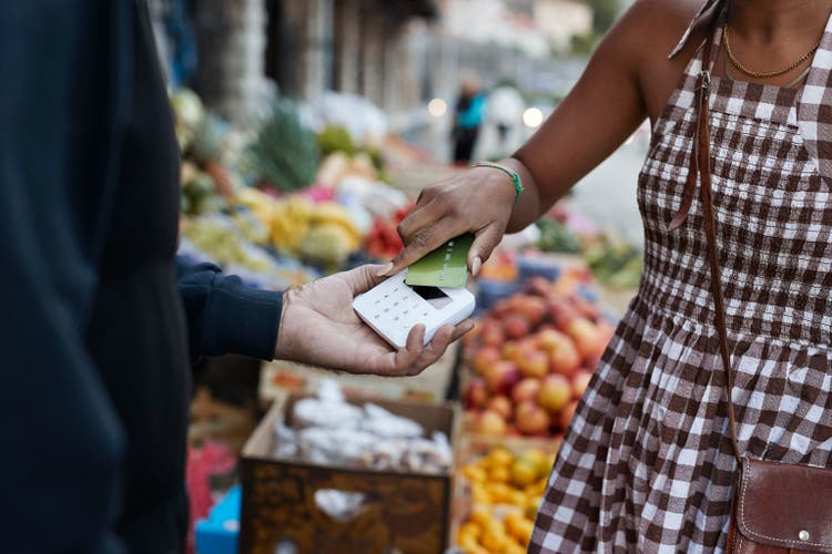 Customer doing credit card payment at market