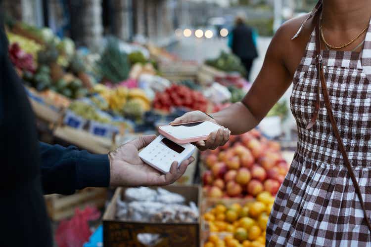 Customer paying through smart phone at market