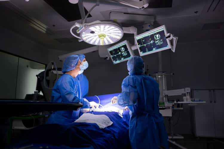Team of surgeons looking at an image in the monitor at the operating room