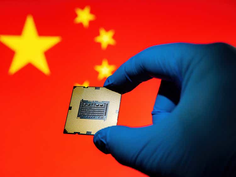 Computer chip microprocessor in the lab glove against China Flag as ideas concept for modern technology