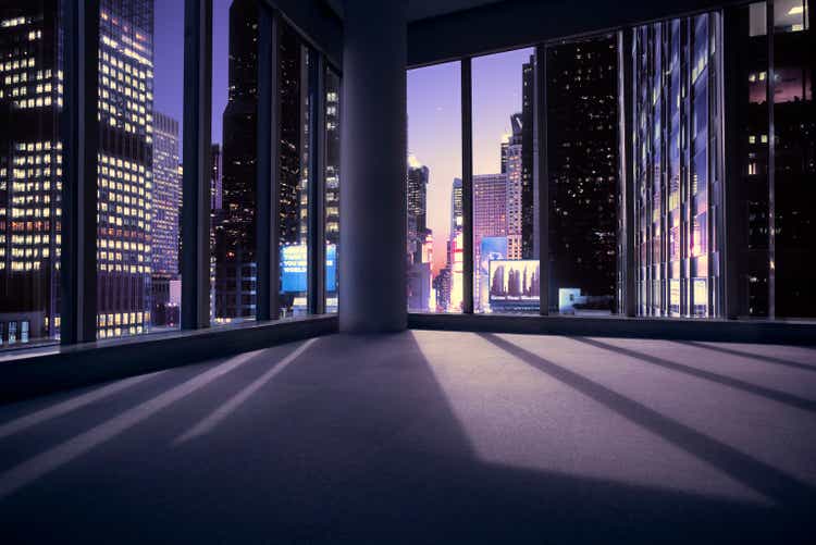 Empty office or apartment with view of Times Square in New York at sunset