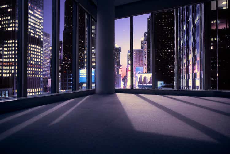 Empty office or apartment overlooking Times Square in New York at sunset