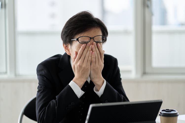 Asian businessman tired at work