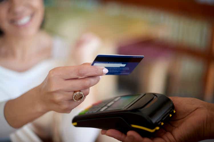 Credit card, hands or payment on a money machine by a happy customer via digital technology in a cafe. Finance, security or happy person shopping, buying or paying cash bill at store or coffee shop