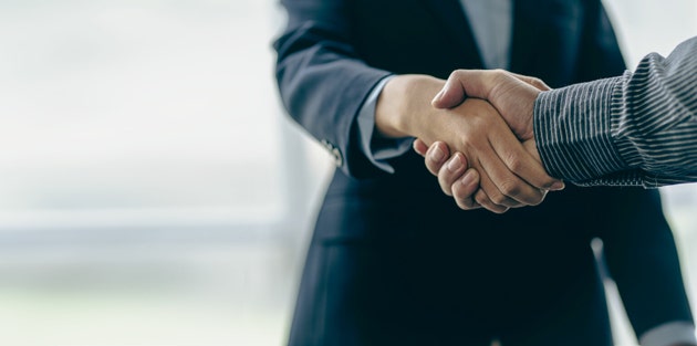Successful negotiation and handshake concept Two businessmen shake hands with partners to celebrate cooperation and teamwork, mergers and acquisitions. Successful negotiations, business deal concept