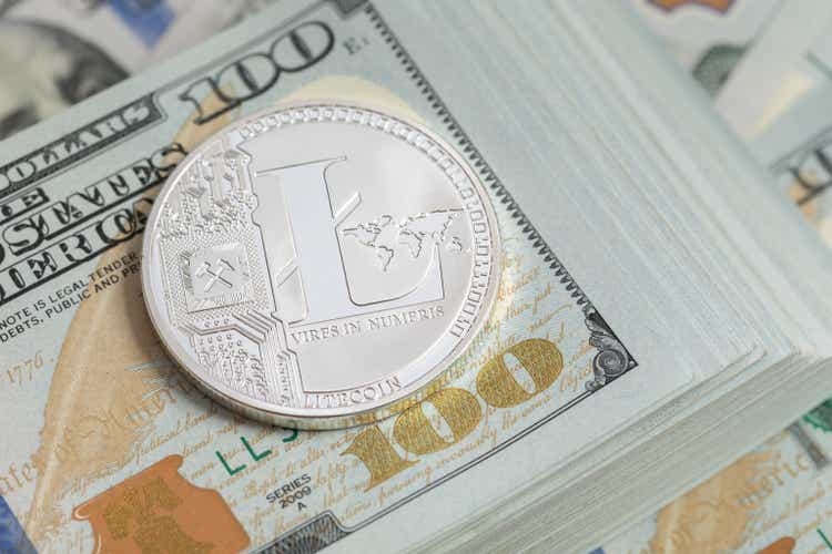 Litecoin lies on a pack of US dollars