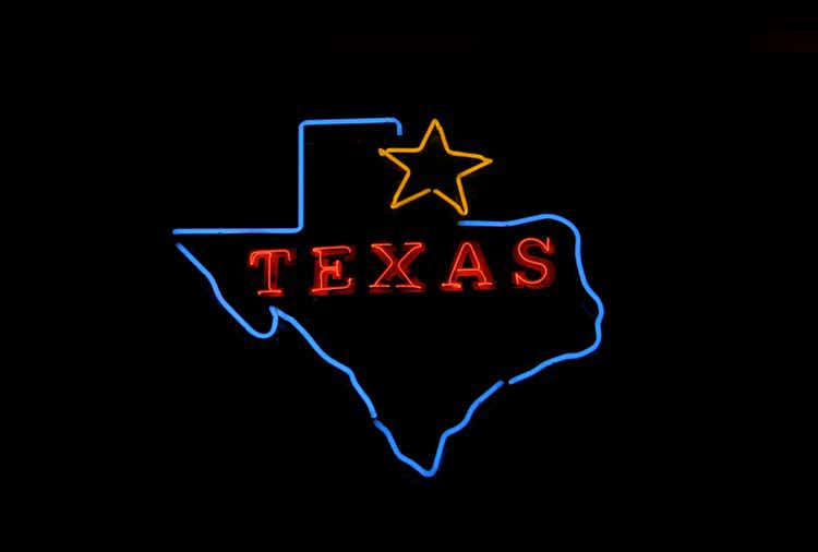 Glowing blue outline of the map of Texas with a golden star and a red text saying Texas inside it