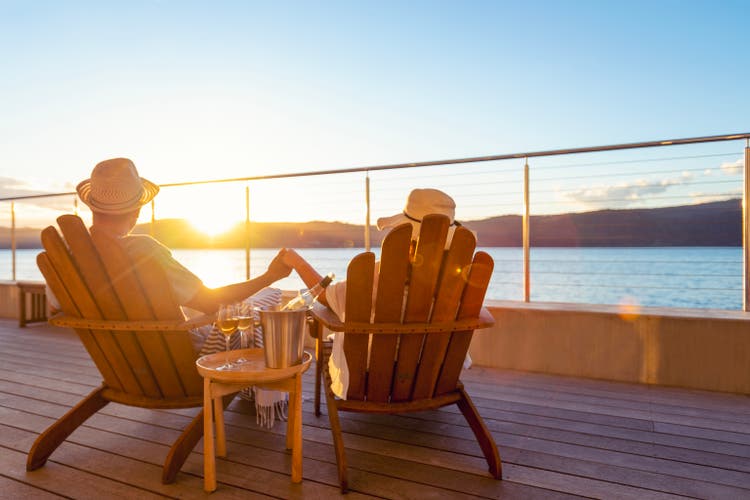 Couple relaxing and drinking wine and holding hands