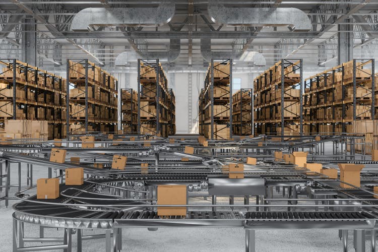 Cardboard Boxes On Conveyor Belt In The Warehouse With Blurred Background