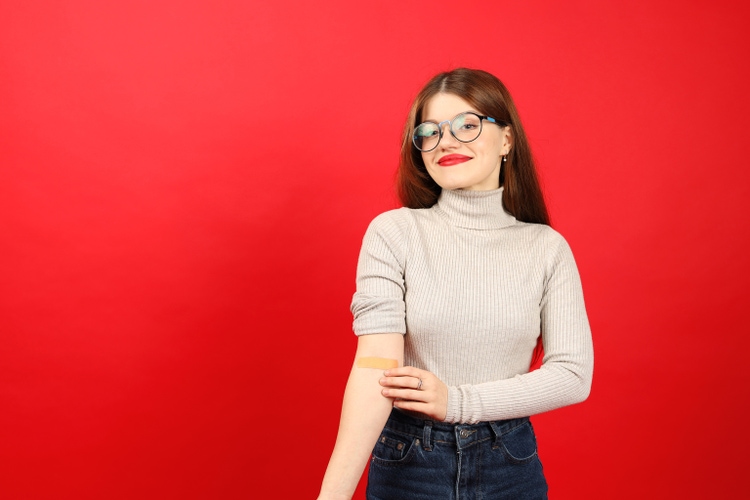 Young woman donor after donating blood plasma, happy volunteer.
