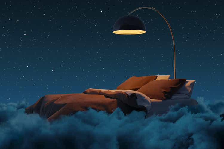 3D rendering of cozy bed illuminated by lamp. The bed flying over fluffy clouds at night