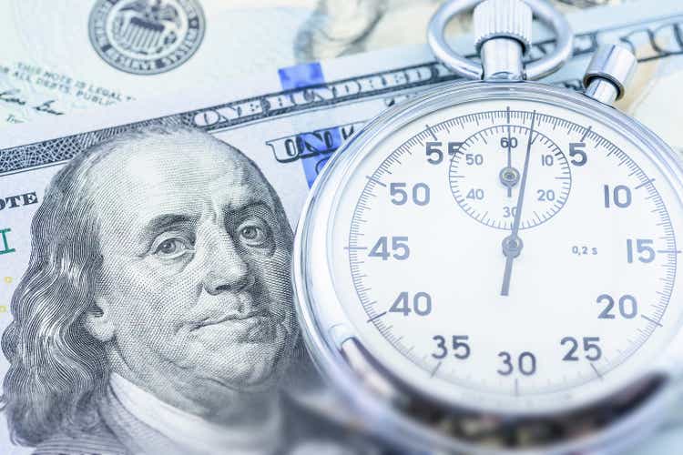 Time is money, value of asset growth over time, financial concept : US USD dollar with a stopwatch, depicting investors deposit or invest for future income or increasing profit in high yield bonds.