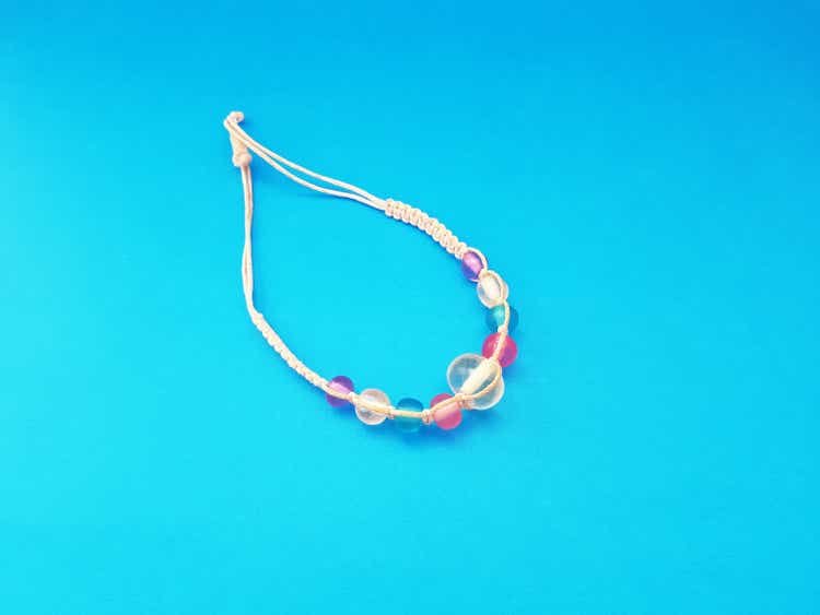 A hand-crafted bracelet, made of transparent beads in various colors