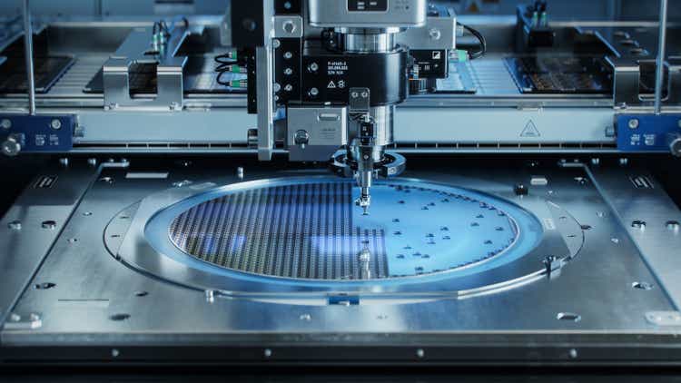 Semiconductor Wafer after Dicing Process. Silicon Dies are Being Extracted by Pick and Place Machine. Computer Chip Manufacturing, Packaging Process.