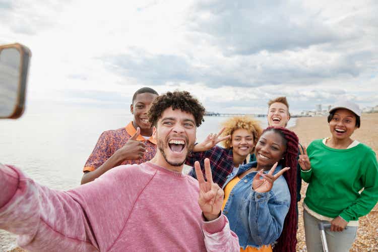 Group of friends taking selfie on sunny beach