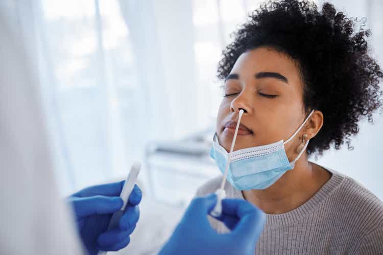 Covid, health and medical test with black woman, nasal swab and doctor with patient, healthcare and face mask. Sample collection for PCR, diagnosis and health care, covid 19 compliance and safety.
