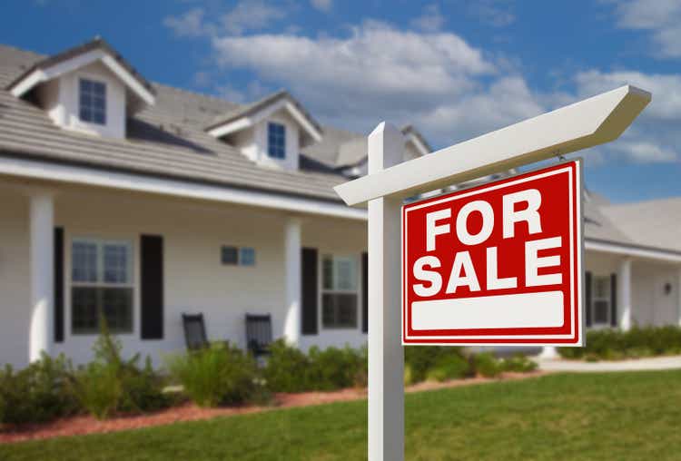 For Sale Real Estate Sign in Front of New House.