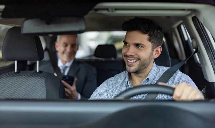 Driver transporting a business man on a crowdsourced taxi