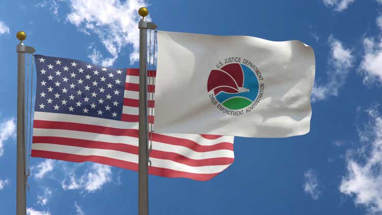USA Flag with DEA Drug Enforcement Administration Flag on a Pole